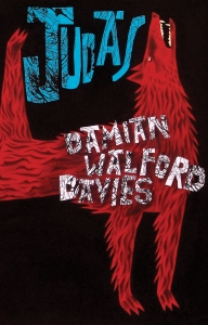 This cover shows a cartoon illustration of a shaggy red wolf, drawn with its head thrown back and its back leg flung in the air. The text reads: Judas, Damian Walford Davies